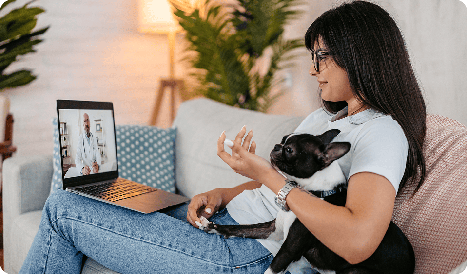 Woman with dog during online consultation